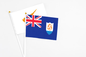 Fototapeta premium Anguilla and Cyprus stick flags on white background. High quality fabric, miniature national flag. Peaceful global concept.White floor for copy space.
