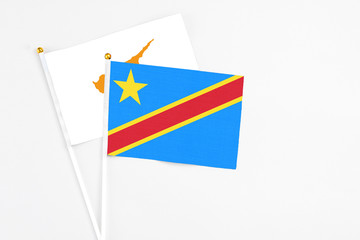 Congo and Cyprus stick flags on white background. High quality fabric, miniature national flag. Peaceful global concept.White floor for copy space.