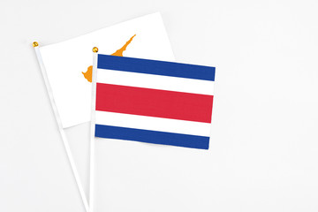 Costa Rica and Cyprus stick flags on white background. High quality fabric, miniature national flag. Peaceful global concept.White floor for copy space.