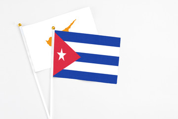 Cuba and Cyprus stick flags on white background. High quality fabric, miniature national flag. Peaceful global concept.White floor for copy space.