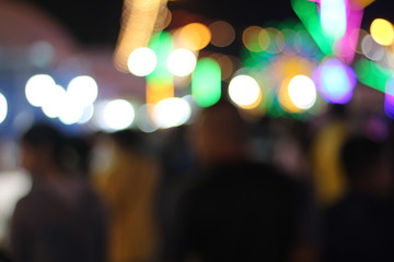 Thai temple festivals, shops and many people walking, blurred.