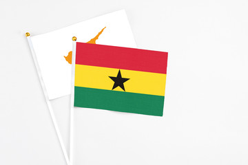 Ghana and Cyprus stick flags on white background. High quality fabric, miniature national flag. Peaceful global concept.White floor for copy space.