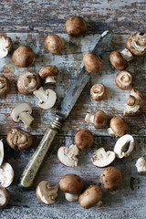 Royal champignons and knife on a wooden surface. Brown champignons. Selective focus. Macro.