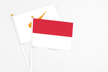 Indonesia and Cyprus stick flags on white background. High quality fabric, miniature national flag. Peaceful global concept.White floor for copy space.