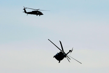 a combat helicopter performs maneuvers in the air