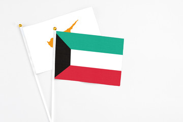 Kuwait and Cyprus stick flags on white background. High quality fabric, miniature national flag. Peaceful global concept.White floor for copy space.