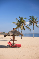   Bali natural beach with parasol on the sand