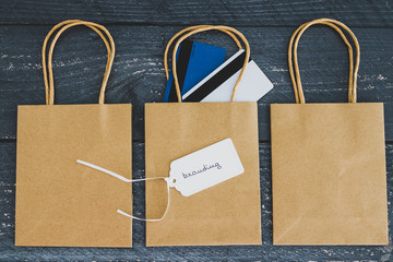 seller's success concept, group of shopping bags with payment cards and price tag with Branding text on one of them