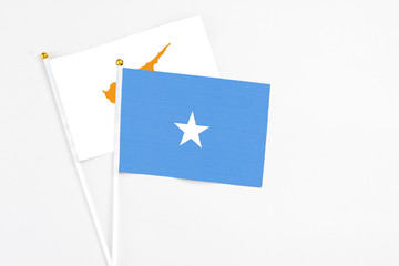 Somalia and Cyprus stick flags on white background. High quality fabric, miniature national flag. Peaceful global concept.White floor for copy space.