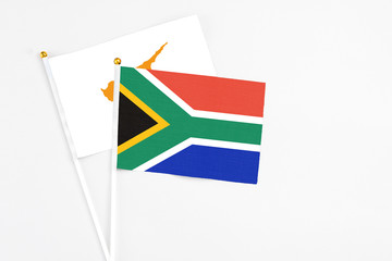South Africa and Cyprus stick flags on white background. High quality fabric, miniature national flag. Peaceful global concept.White floor for copy space.