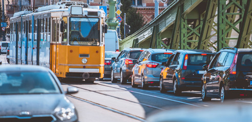 Obraz premium Traffic jam in crowded city street tram and cars