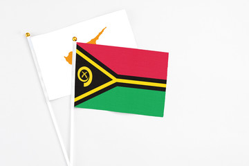 Vanuatu and Cyprus stick flags on white background. High quality fabric, miniature national flag. Peaceful global concept.White floor for copy space.