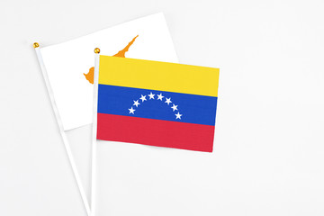 Venezuela and Cyprus stick flags on white background. High quality fabric, miniature national flag. Peaceful global concept.White floor for copy space.