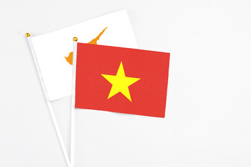Vietnam and Cyprus stick flags on white background. High quality fabric, miniature national flag. Peaceful global concept.White floor for copy space.