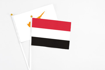 Yemen and Cyprus stick flags on white background. High quality fabric, miniature national flag. Peaceful global concept.White floor for copy space.
