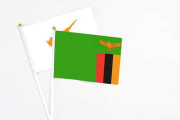 Zambia and Cyprus stick flags on white background. High quality fabric, miniature national flag. Peaceful global concept.White floor for copy space.