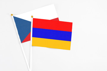 Armenia and Cyprus stick flags on white background. High quality fabric, miniature national flag. Peaceful global concept.White floor for copy space.