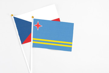 Aruba and Cyprus stick flags on white background. High quality fabric, miniature national flag. Peaceful global concept.White floor for copy space.