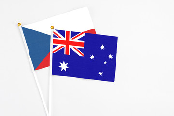 Fototapeta premium Australia and Cyprus stick flags on white background. High quality fabric, miniature national flag. Peaceful global concept.White floor for copy space.