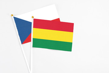 Bolivia and Cyprus stick flags on white background. High quality fabric, miniature national flag. Peaceful global concept.White floor for copy space.