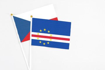 Cape Verde and Cyprus stick flags on white background. High quality fabric, miniature national flag. Peaceful global concept.White floor for copy space.