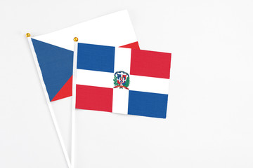 Dominican Republic and Cyprus stick flags on white background. High quality fabric, miniature national flag. Peaceful global concept.White floor for copy space.