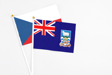 Fototapeta premium Falkland Islands and Cyprus stick flags on white background. High quality fabric, miniature national flag. Peaceful global concept.White floor for copy space.