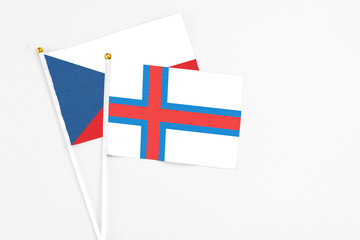 Faroe Islands and Cyprus stick flags on white background. High quality fabric, miniature national flag. Peaceful global concept.White floor for copy space.