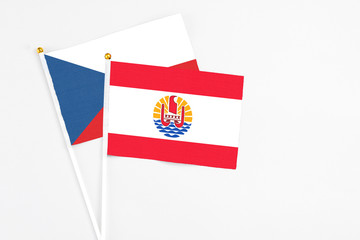 French Polynesia and Cyprus stick flags on white background. High quality fabric, miniature national flag. Peaceful global concept.White floor for copy space.