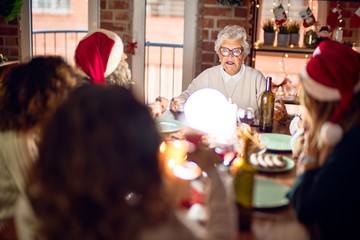 Beautiful group of women smiling happy and confident. Eating roasted turkey celebrating christmas at home