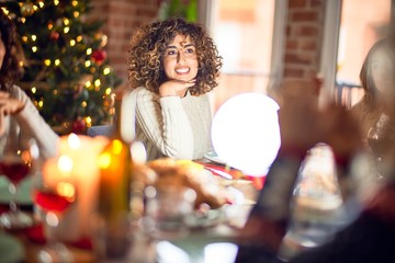 Beautiful group of women smiling happy and confident. Eating roasted turkey celebrating christmas at home