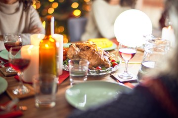 Beautiful group of women smiling happy and confident. Eating roasted turkey celebrating christmas at home