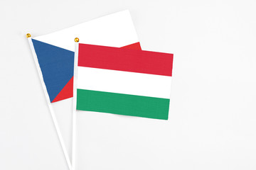 Hungary and Cyprus stick flags on white background. High quality fabric, miniature national flag. Peaceful global concept.White floor for copy space.