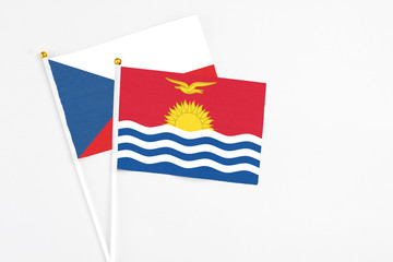 Kiribati and Cyprus stick flags on white background. High quality fabric, miniature national flag. Peaceful global concept.White floor for copy space.