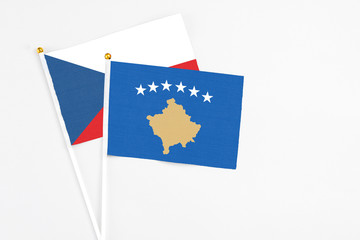 Kosovo and Cyprus stick flags on white background. High quality fabric, miniature national flag. Peaceful global concept.White floor for copy space.