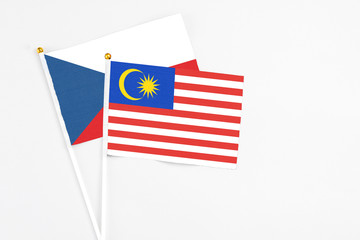 Malaysia and Cyprus stick flags on white background. High quality fabric, miniature national flag. Peaceful global concept.White floor for copy space.