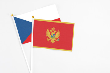 Montenegro and Cyprus stick flags on white background. High quality fabric, miniature national flag. Peaceful global concept.White floor for copy space.