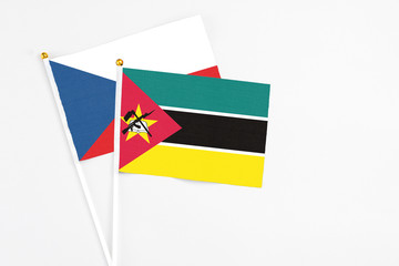 Mozambique and Cyprus stick flags on white background. High quality fabric, miniature national flag. Peaceful global concept.White floor for copy space.