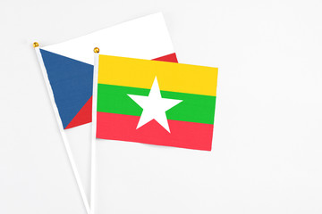 Myanmar and Cyprus stick flags on white background. High quality fabric, miniature national flag. Peaceful global concept.White floor for copy space.