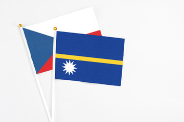 Nauru and Cyprus stick flags on white background. High quality fabric, miniature national flag. Peaceful global concept.White floor for copy space.