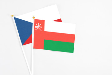 Oman and Cyprus stick flags on white background. High quality fabric, miniature national flag. Peaceful global concept.White floor for copy space.