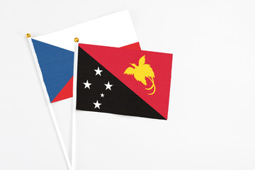 Papua New Guinea and Cyprus stick flags on white background. High quality fabric, miniature national flag. Peaceful global concept.White floor for copy space.