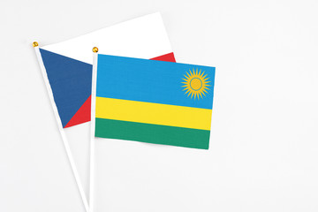 Rwanda and Cyprus stick flags on white background. High quality fabric, miniature national flag. Peaceful global concept.White floor for copy space.