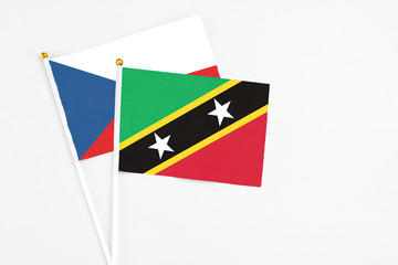 Saint Kitts And Nevis and Cyprus stick flags on white background. High quality fabric, miniature national flag. Peaceful global concept.White floor for copy space.