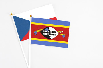 Swaziland and Cyprus stick flags on white background. High quality fabric, miniature national flag. Peaceful global concept.White floor for copy space.