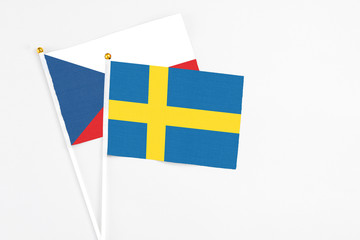 Sweden and Cyprus stick flags on white background. High quality fabric, miniature national flag. Peaceful global concept.White floor for copy space.