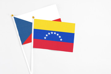 Venezuela and Cyprus stick flags on white background. High quality fabric, miniature national flag. Peaceful global concept.White floor for copy space.