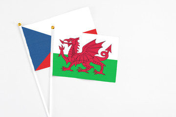 Wales and Cyprus stick flags on white background. High quality fabric, miniature national flag. Peaceful global concept.White floor for copy space.