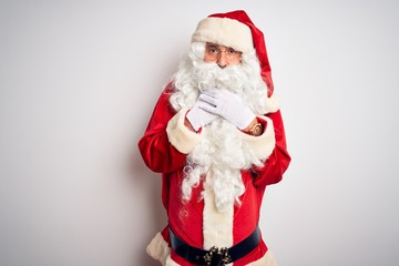 Middle age handsome man wearing Santa costume standing over isolated white background shouting suffocate because painful strangle. Health problem. Asphyxiate and suicide concept.