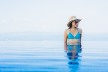 Fototapeta premium Portrait beautiful young asian women happy smile relax outdoor swimming pool in resort